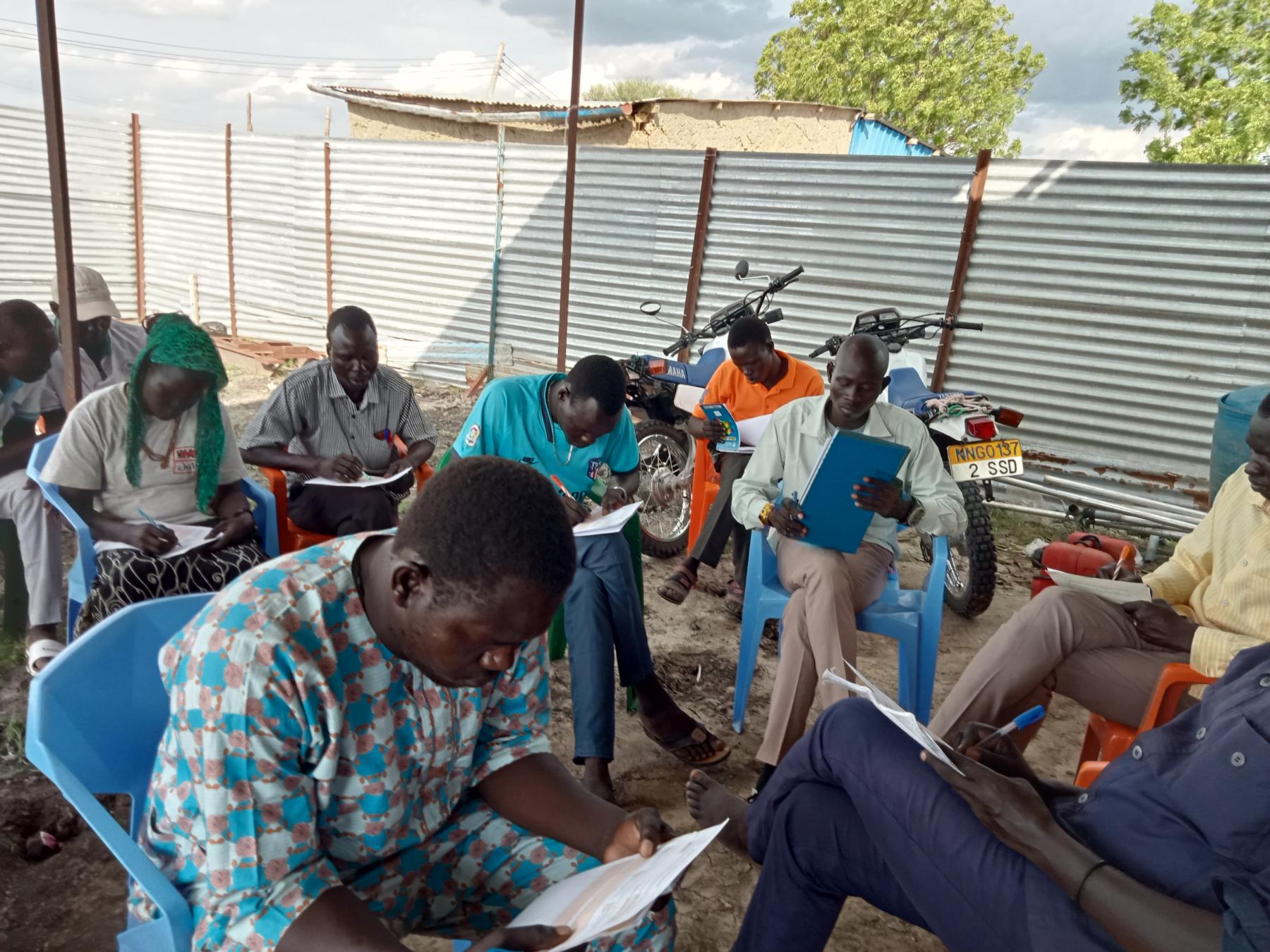 WOCO staff going through a note on child protection-photo courtesy by WOCO