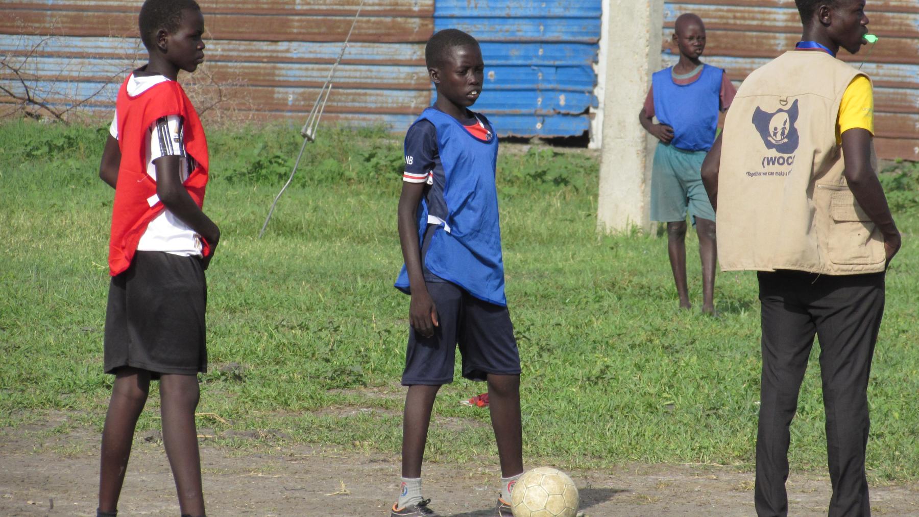 Children play football as one of the life skills