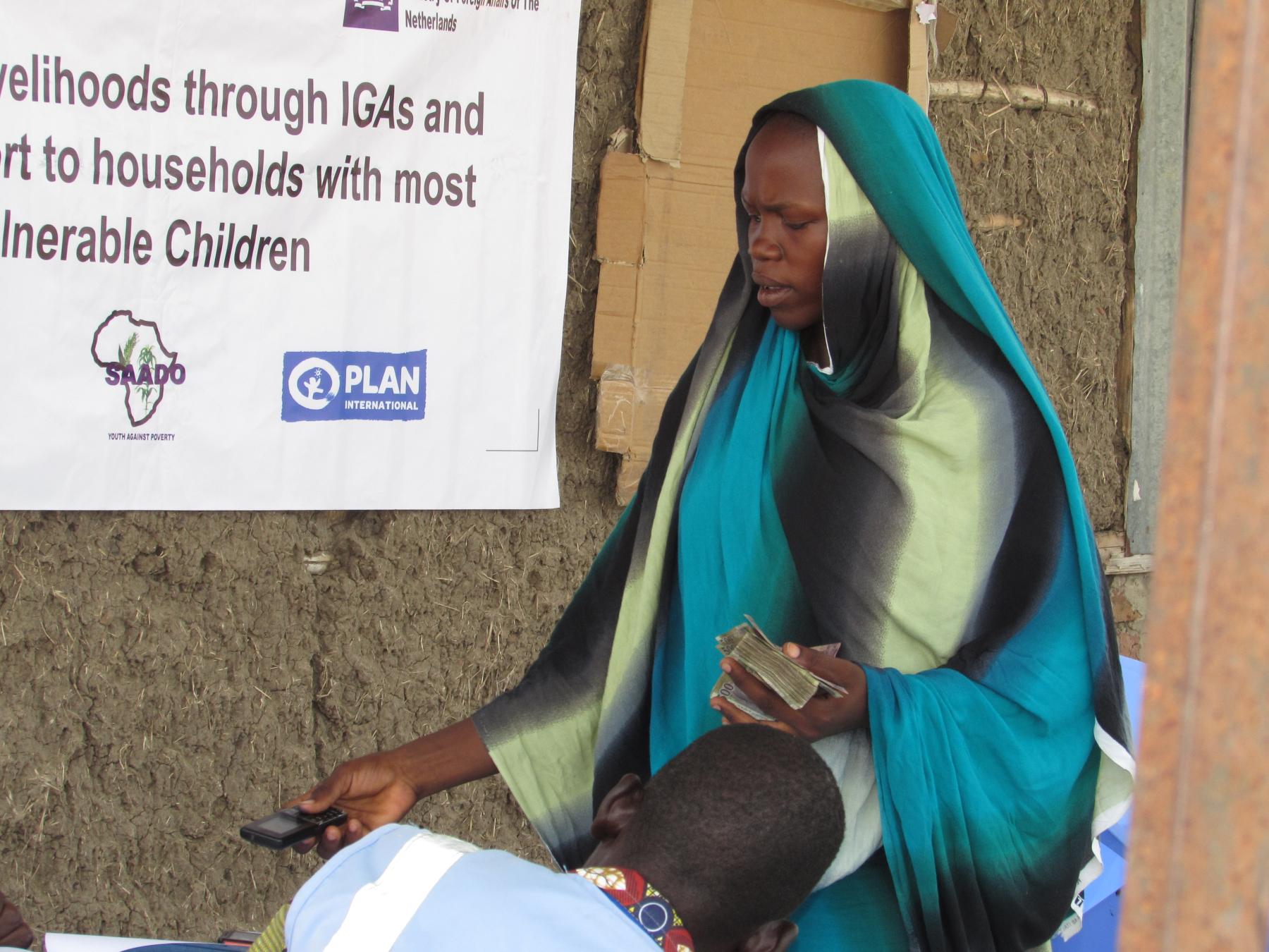 A beneficiary is signing payment sheet for IGA support