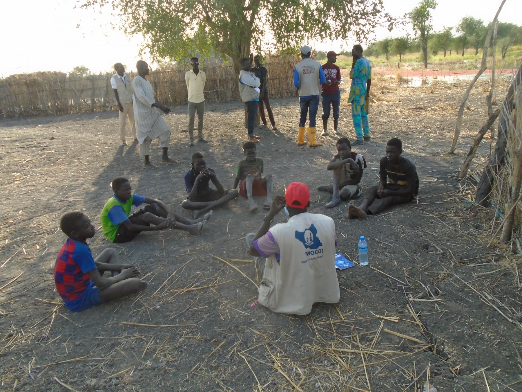 WOCO project officer engaging children in discussion to collect their views on the effect of flood 